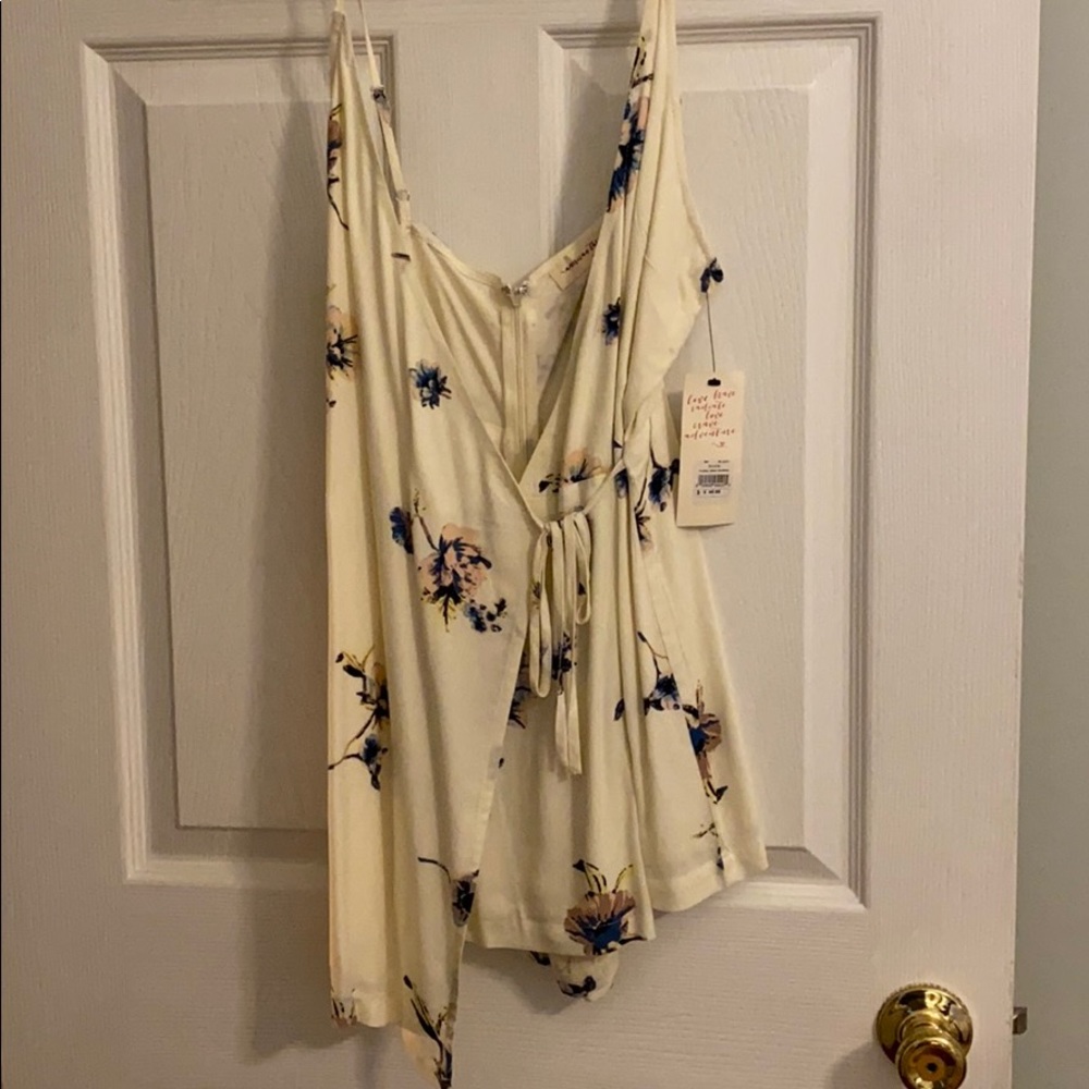 Floral romper with front tie wrap.